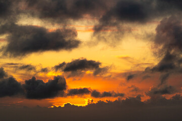 Wall Mural - Sky with Colorful Pink Golden and Dark Clouds at Sunset. Abstract Texture Background Pattern.