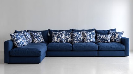 Poster - Plush navy sectional couch with decorative patterned cushions sits against a clean white backdrop, providing ample copy space on the left for design use