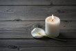 © AdityaGM - Peaceful Candle and Calla Lily on Rustic Wooden Table. Generative Ai