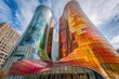 © AHNH5 - Vibrant Glass Architecture in Urban Setting with Colorful Reflections