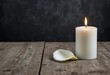 © AdityaGM - Peaceful Candle and Calla Lily on Rustic Wooden Table. Generative Ai