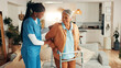 © peopleimages.com - Nurse, senior woman and home with walker, happy or support for recovery with injury in living room. Caregiver, frame and elderly patient with disability with talk, smile and rehabilitation in lounge