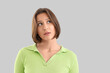 © Pixel-Shot - Wondering young woman on light background, closeup