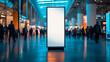 © Favio - Vertical blank banner stand placed in the center of a busy tradeshow hall with blurred visitors.