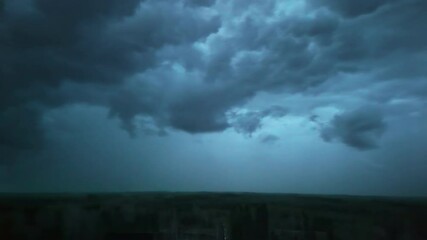 Wall Mural - dark sky with stormy clouds over rural landscape. timelapse