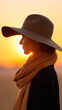 © Ruzana - Peaceful woman in wide brim hat silhouette against golden sunset