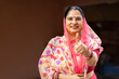© Pix4Ads - Rural Indian middle class Woman showing thumbs up with Standing at home. Cheerfully posing in front of the camera - leisure time, Rural india women empowerment