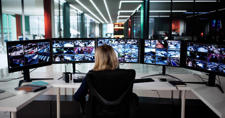 Poster - Woman Using Computer To Monitor Security Cameras In Control Room