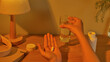 © Tuan  Nguyen  - The patient takes medication before going to bed with vitamin capsules placed in the palm of one hand the other hand holding a glass of water ready to drink. The daily dose is placed on the table.