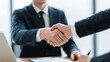 © kinotescreative - Business partners shaking hands over a successful deal