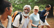 © DavidL2000/peopleimages.com - Fitness, laugh and people in nature for hiking, explore environment or journey on trail. Happy group, woman guide and trekking in forest for exercise, explain route or outdoor for wellness activity