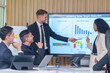 © Prapol Srinakara - business meeting or seminar,happy multiracial business team conference,presentation with statistic report ,brainstorming in office room