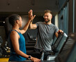 © Lumos sp - gym sport fitness exercise health training woman teamwork happy together friend success high five trainer instructor gesture support coach motivation treadmill running man trainer instructor coach