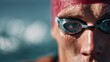 © Suphawan - Swimmer with a focused expression, wearing a swim cap and goggles, ready to plunge into the pool