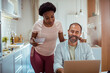 © Davor - Happy couple spending quality time together in modern kitchen with laptop and breakfast