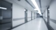 © Art - Blurred hospital corridor with doors and lights in a sterile environment.