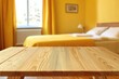 © faki - Wooden table in a yellow bedroom