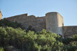 © Kepler - Historic stone fortress with turret against clear sky and greenery