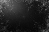 Black background with white dust, scratches texture. Grunge abstract design, film grain overlay for vintage effects, poster, digital design templates. Aged dirty overlay. Rough surface.
