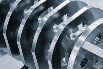 Poster - A series of metal cylinders with holes in them. The cylinders are stacked on top of each other.