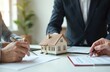 © miss irine - Real estate agent presents home loan contract to client. Customer discusses mortgage details, signing house rental insurance with approved property form. Banking concept, financial advisor services.