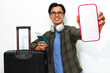 © Muhammad Alimaki - Excited young Asian man in casual attire carrying a suitcase and showing a blank mobile phone screen for advertising, while holding a passport. Isolated on a white background.