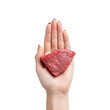 © Ouzhan - A hand delicately holding a fresh slice of red meat, ready for cooking or consumption