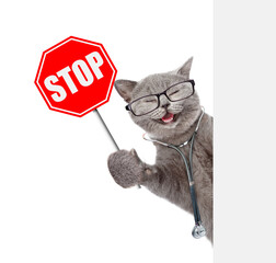 Aufkleber - Happy cat dressed like a doctor with stethoscope on his neck looks from behind blank white banner and shows stop sign. isolated on white background