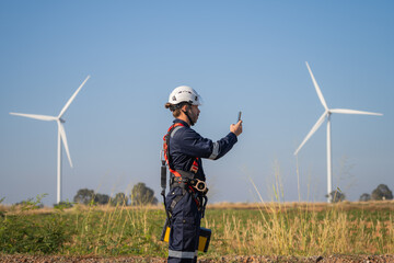 Aufkleber - Engineer man working with tablet at windmill farm Generating electricity clean energy. Wind turbine farm generator by alternative green energy.