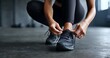 © Graini - Woman Tying Running Shoe Laces Fitness Workout Gym Exercise