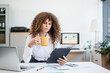 © Phushutter - Confident Russian consultant sits at modern desk, analyzing market data on laptop. reports and charts, she embodies precision, leadership, and strategic mindset of corporate consulting.