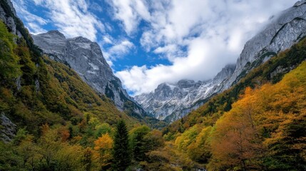 Poster - Majestic mountain valley in autumn, showcasing vibrant foliage against towering, snow-dusted peaks under a partly cloudy sky. : Generative AI