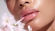 © Tondo - Glossy lips with lip gloss applicator and spring flowers