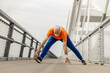© Dusan Petkovic - Full length of senior sportsman warming up on a bridge.