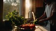 © Suphawan - Morning kitchen light illuminating a man washing vegetables in the sink, fresh parsley and tomatoes in view