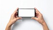 © Atikoh - Hands holding mobile phone horizontally with blank white screen for app promotion or presentation on white background providing space for graphic design