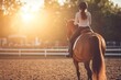 © Ольга Лукьяненко - Young girl riding horse in sunlit equestrian arena