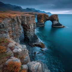 Aufkleber - Dramatic coastal rock formations with natural arches create a stunning seascape under a moody sky, showcasing the rugged beauty of Iceland's coastline. : Generative AI