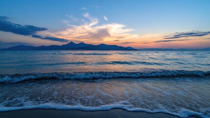 Poster - Serene sunset over the ocean with gentle waves lapping the shore, showcasing a picturesque mountain range in the distance under a vibrant sky. : Generative AI