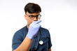 © ArvStd - Confident asian male nurse, doctor in medical rubber gloves, holding syringe with vaccine, standing white background