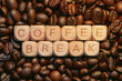 © bykot - Coffee break concept with wooden blocks and coffee beans