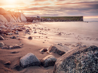 Wall Mural - View on peaceful Galway bay and Burren mountains from rough stone coast. Water surface is smooth and gives relaxing feel and mood. Irish nature landscape scene. Nobody. Cloudy sky.