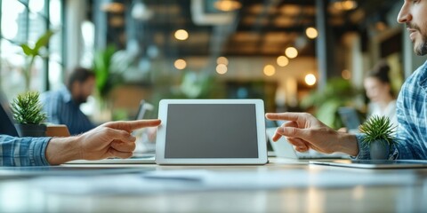 Fototapete - Two colleagues collaborate, pointing at a tablet screen displaying a blank interface in a modern, brightly lit coworking space. : Generative AI