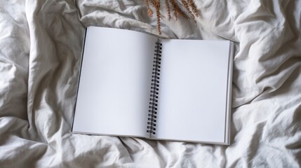 Poster - Open spiral notebook with blank pages rests on a beige fabric, creating a minimalist and serene scene. : Generative AI