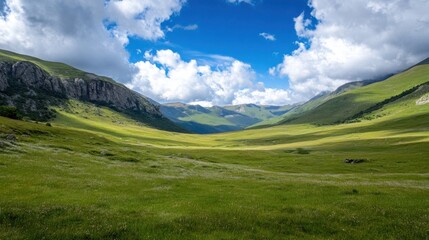 Aufkleber - Serene mountain valley landscape with lush green meadows under a vibrant blue sky dotted with fluffy white clouds, showcasing a picturesque natural scene. : Generative AI