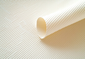Aufkleber - Cream-colored ribbed paper texture, elegantly rolled and displayed, showcasing its subtle texture and soft light reflection. : Generative AI