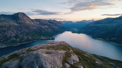 Fototapete - Serene sunset view over a fjord, nestled between majestic mountains and a small coastal village.  The tranquil water reflects the soft evening light, creating a breathtaking panorama. : Generative AI