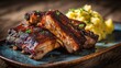 © Koplexs-Stock - Glazed ribs and mashed potatoes on a plate on a wooden surface.