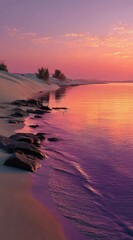 Fototapete - Serene sunset over a tranquil beach, showcasing pink and purple hues reflecting on calm water, with gentle waves lapping the sandy shore and dark rocks scattered along the coastline. : Generative AI