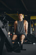 © Davidovici - Fit man with a muscular build pauses to rest after an intense rowing session. His focused expression and tired yet resolute demeanor showcase the commitment and effort of his fitness regimen